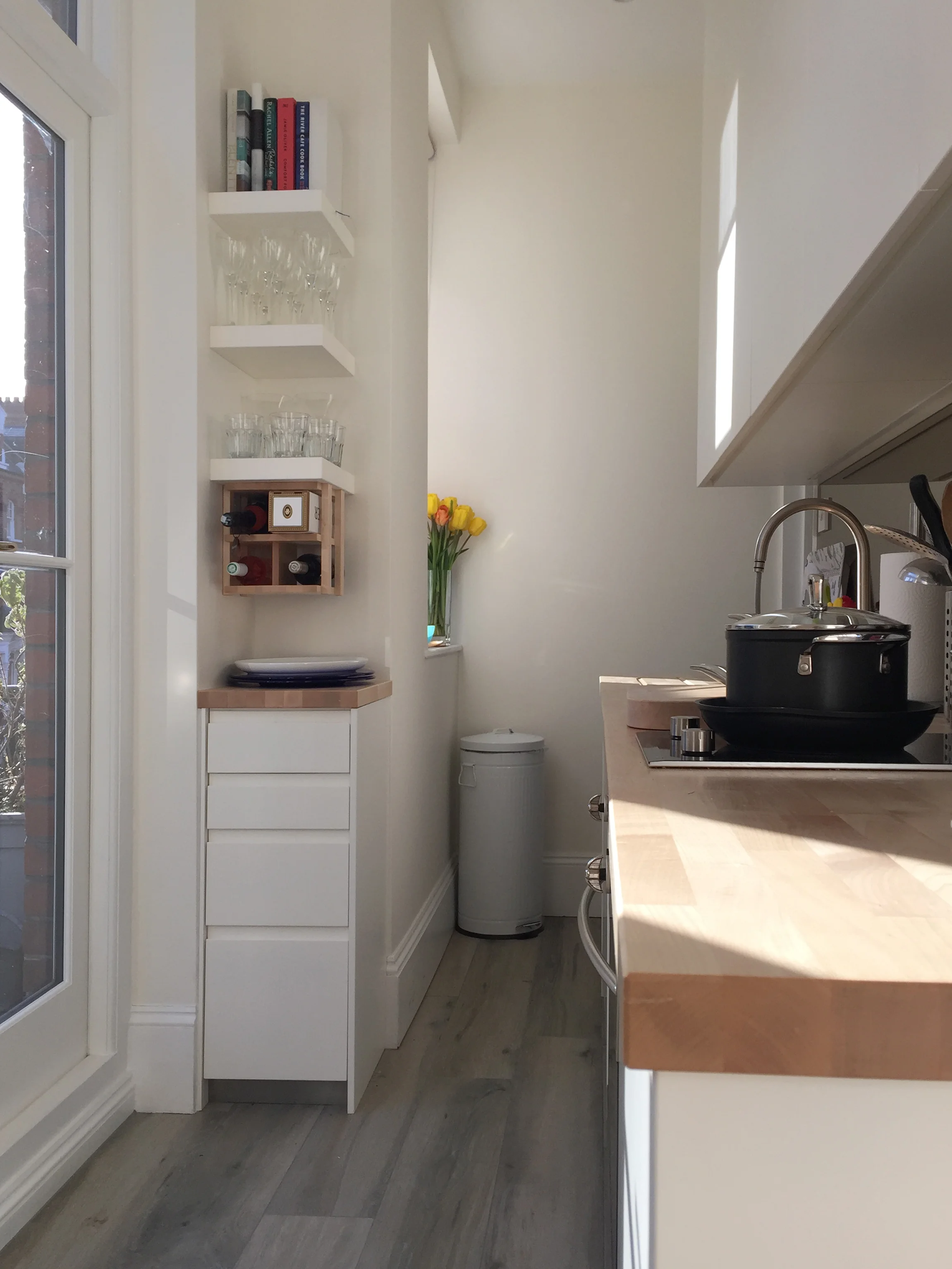 Compact galley kitchenBuilt-in cabinetry, wall shelving, drawer unit, wine rack and solid maple counter tops.