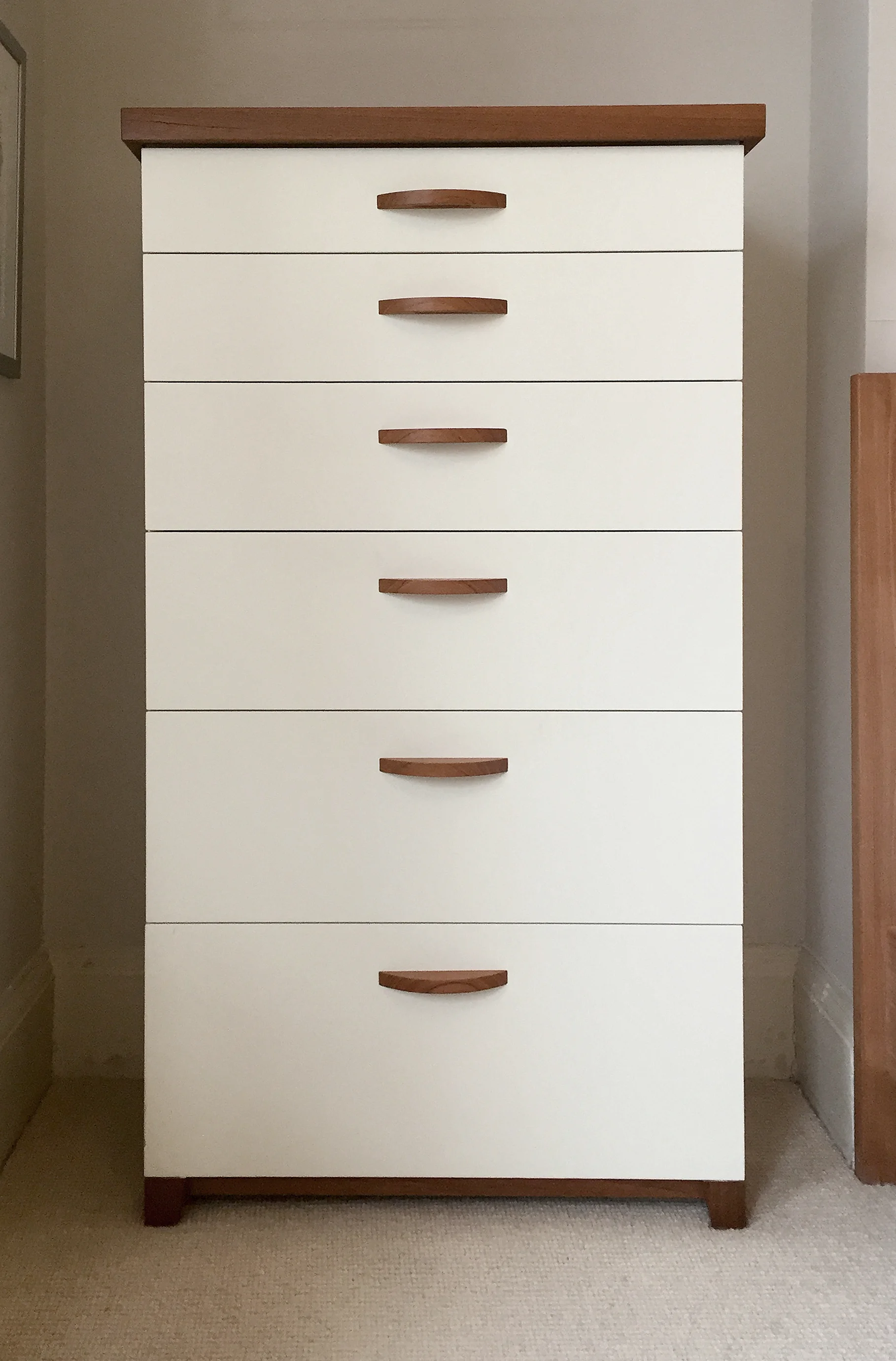 Tallboy dresser with solid teak top, feet and base and handles.