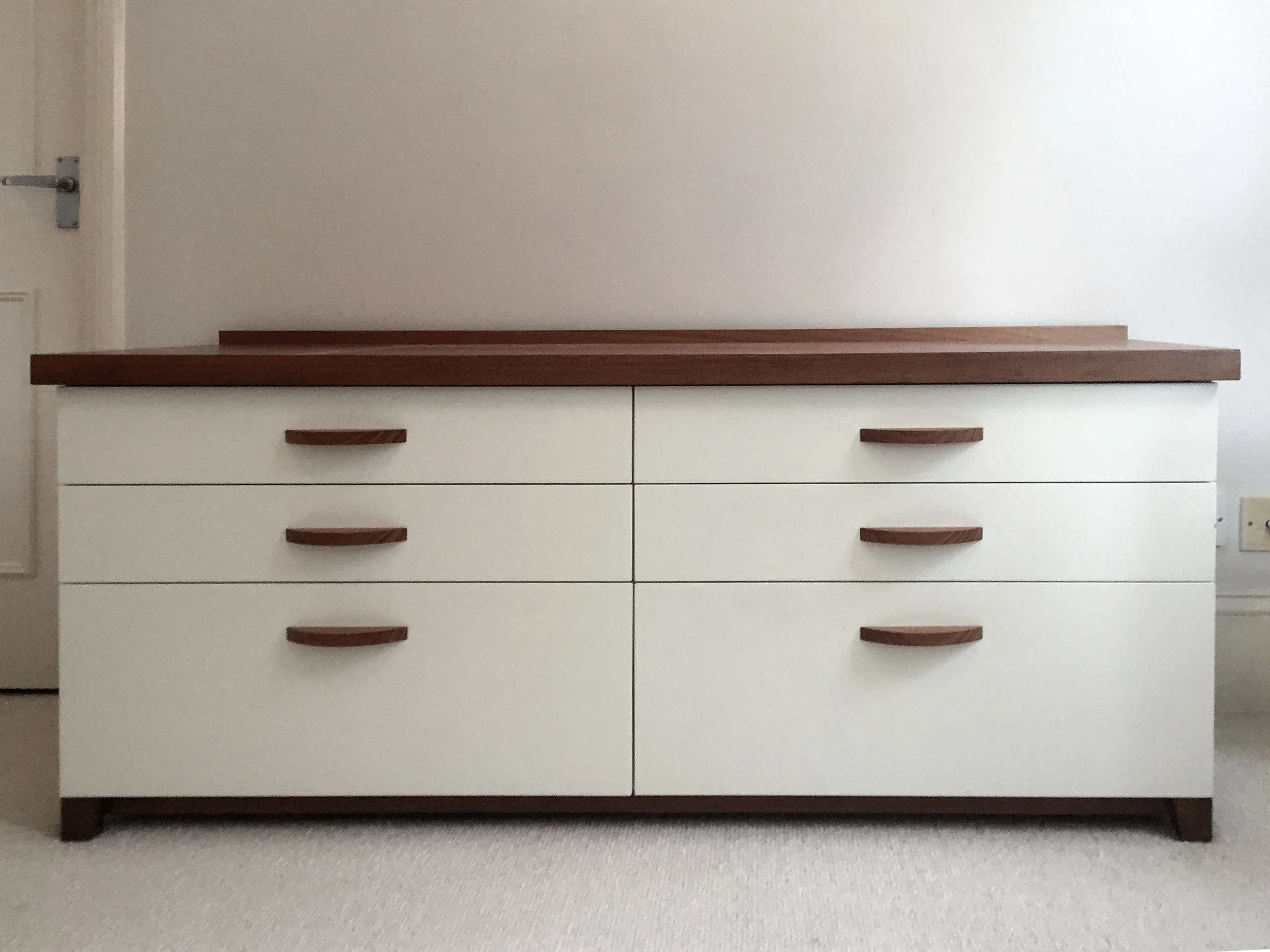 Lowboy dresser with solid teak top, feet and base and handles.