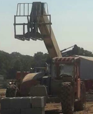 Unoccupied forklift with forks in the air