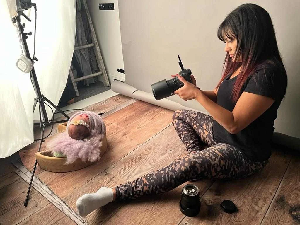 Tamara Vaz Photographing a newborn baby posed in a moon wood prop