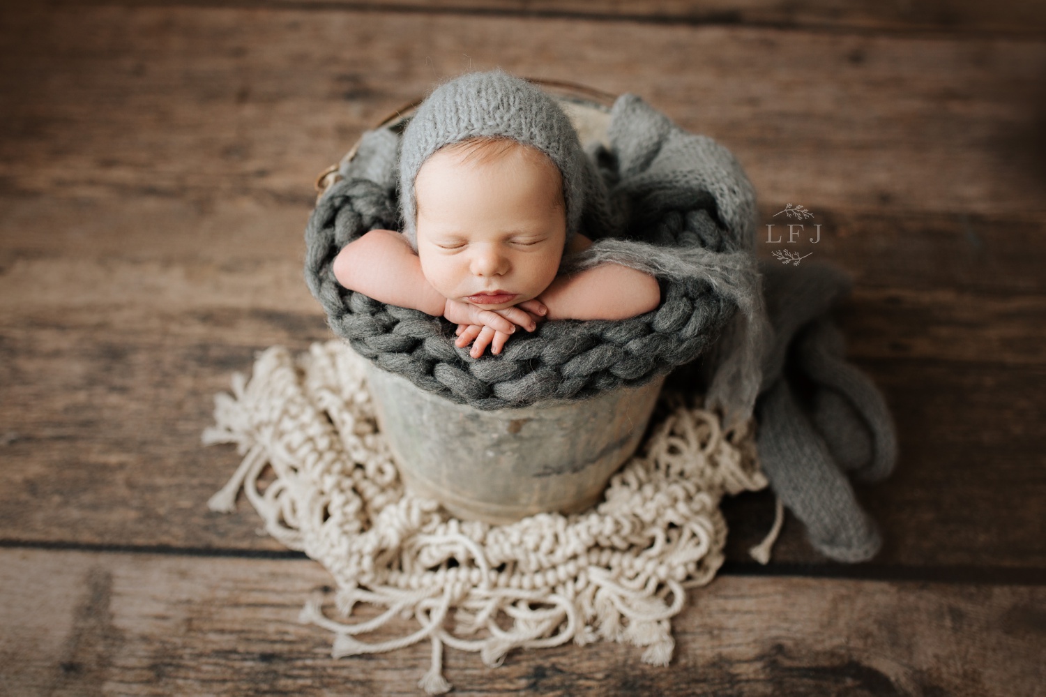 baby boy in a bucket posed in Lincoln Park NJ photography studio