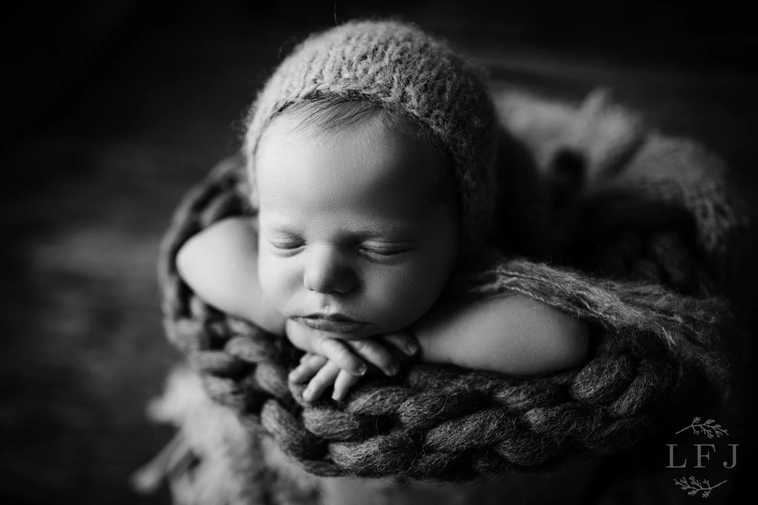 black and white image of baby boy in a bucket