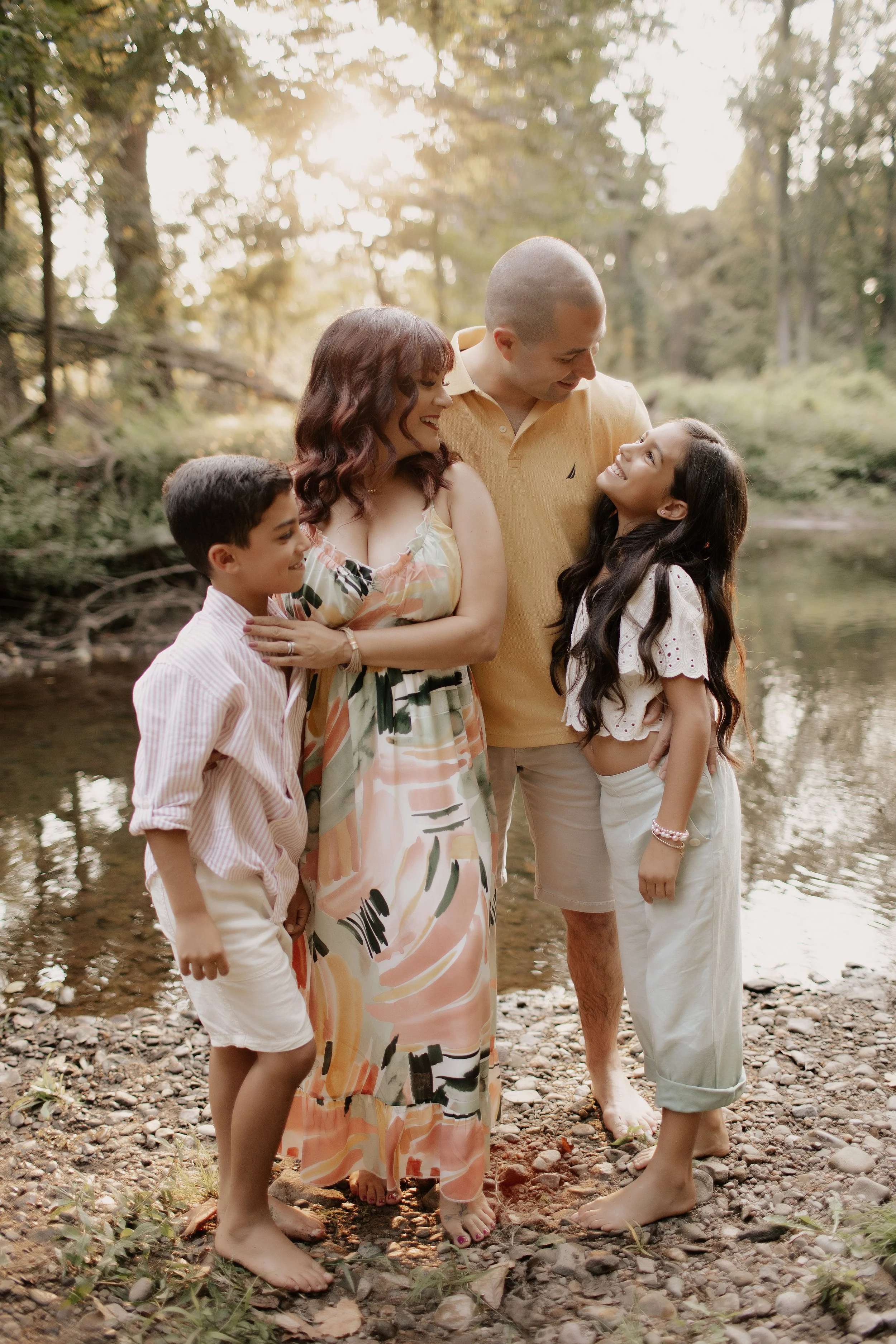 Tamara Vaz Family picture at a river during sunset.