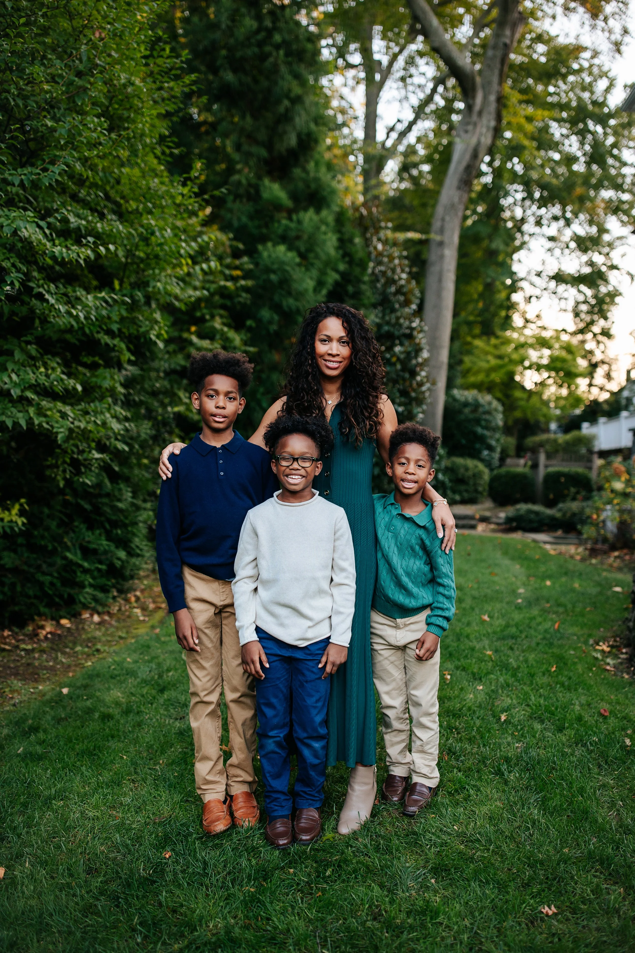 Mom and kids looking at the camera in their backyard in Maplewood, NJ