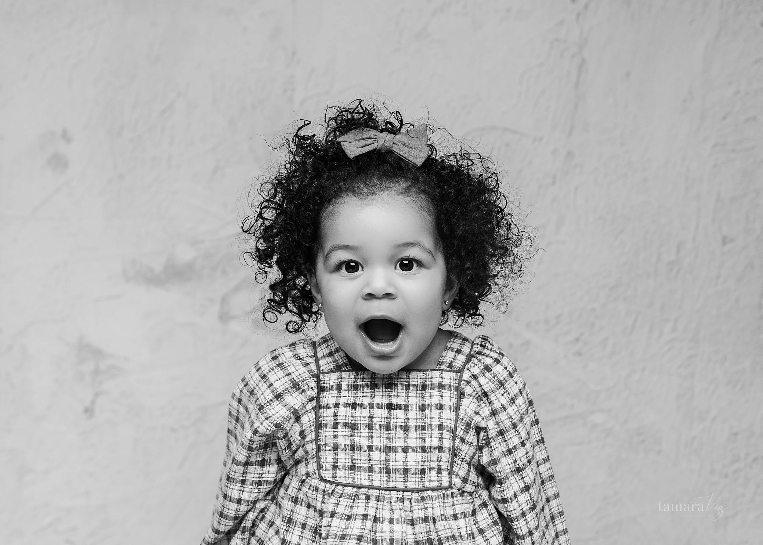 Black and white image of toddler acting surprised looking at the camera in Wayne, NJ photography session