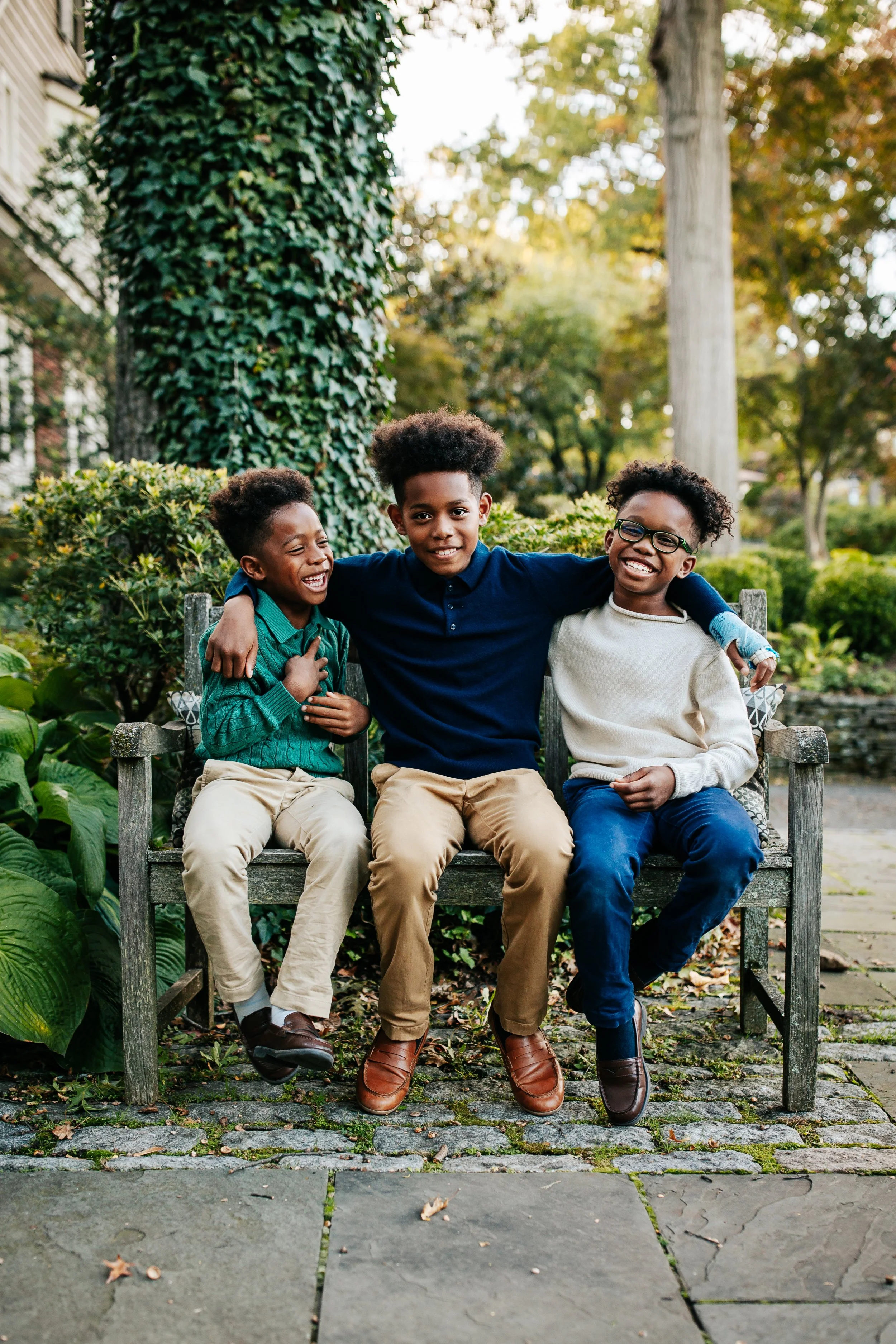 African American brothers sitting on a bench during their family in-home photo session