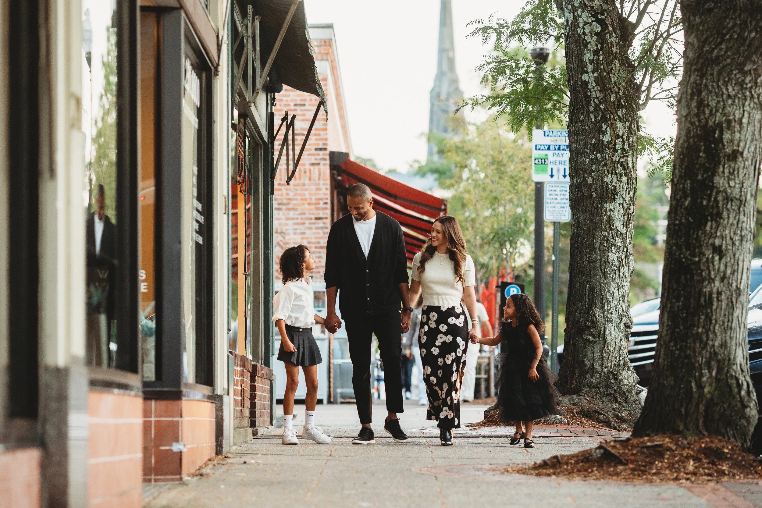 Faniy walking down Franklin Ave in Ringwood NJ for their urban family photoshoot. parents and kids look happy and having fun