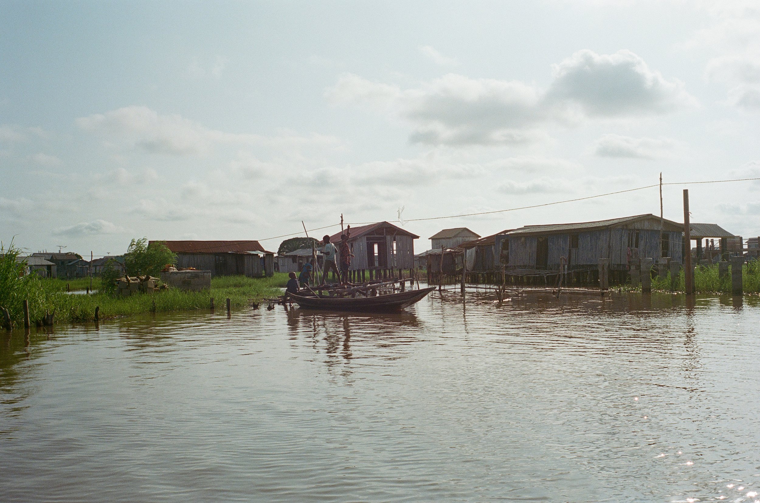  There are no streets in the village, only waterways. People get around on longboats, often driven by youth, as depicted here. 