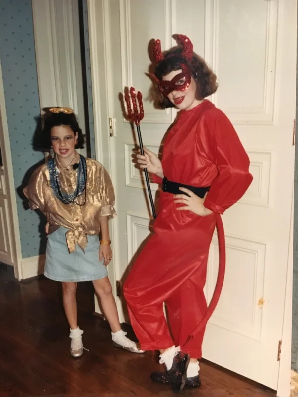 I’m not sure what sister’s character was. The “costume” she is wearing is what I wore to school like every Friday of 6th grade.