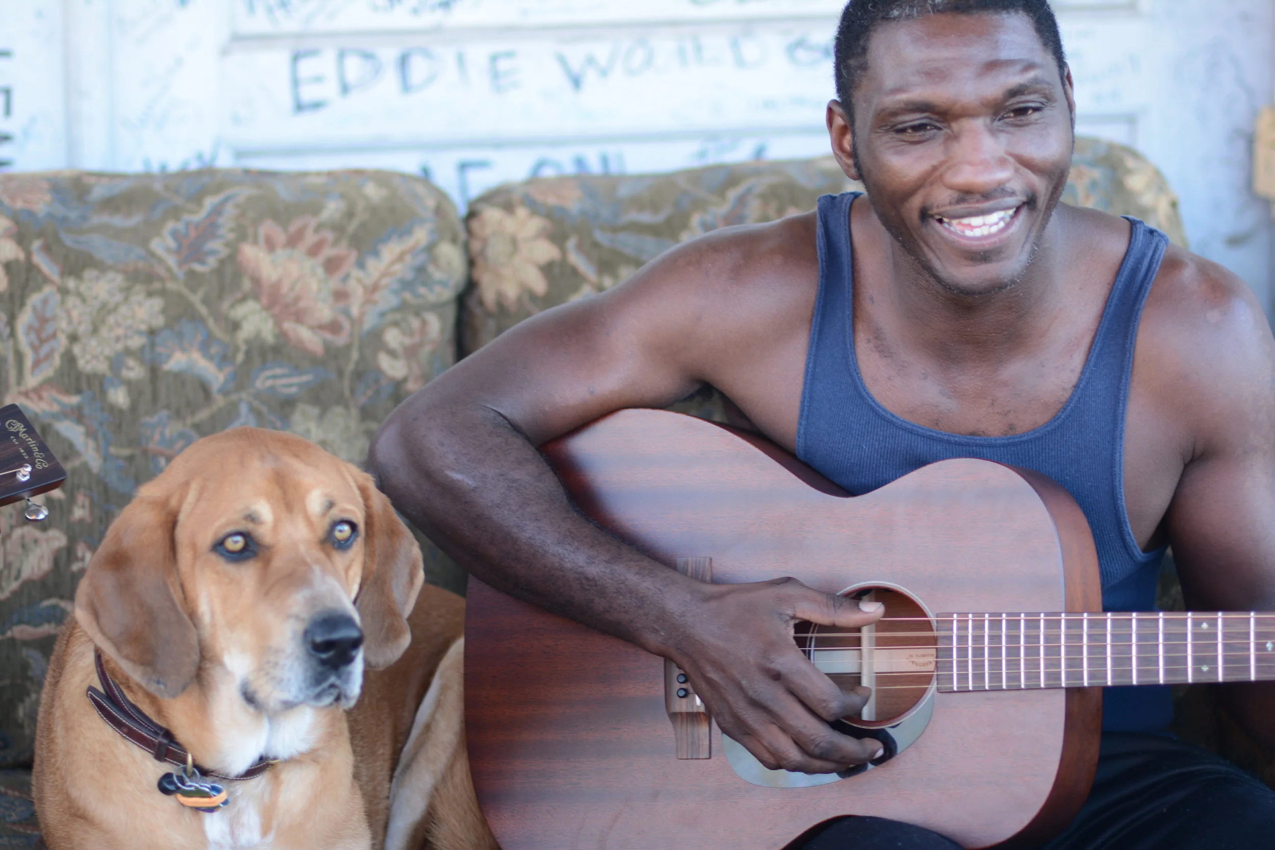 Multiple Grammy nominated artist Cedric Burnside and his four legged friend Abigail on the porch at Ground Zero Blues Club, Clarksdale, Mississippi.