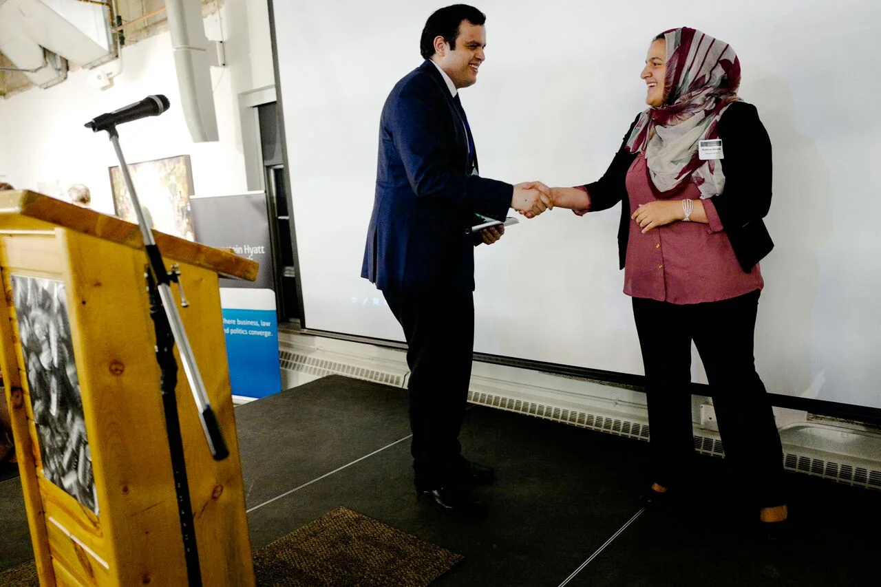 Edgar Barraza (left) accepts his Immigrant Liberty Award from Master of Ceremonies, Nadeen Ibrahim.