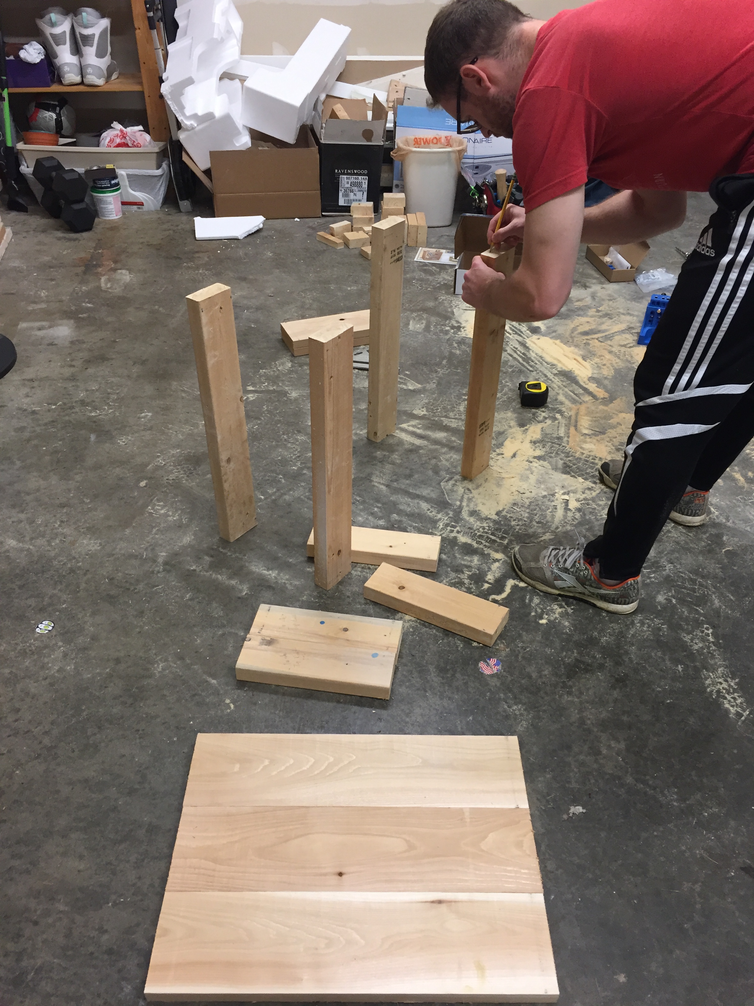 Marking our cut pieces to make sure we had our favorite sides showing. We used cedar for the table top, and screwed the pieces together with pocket hole screws.