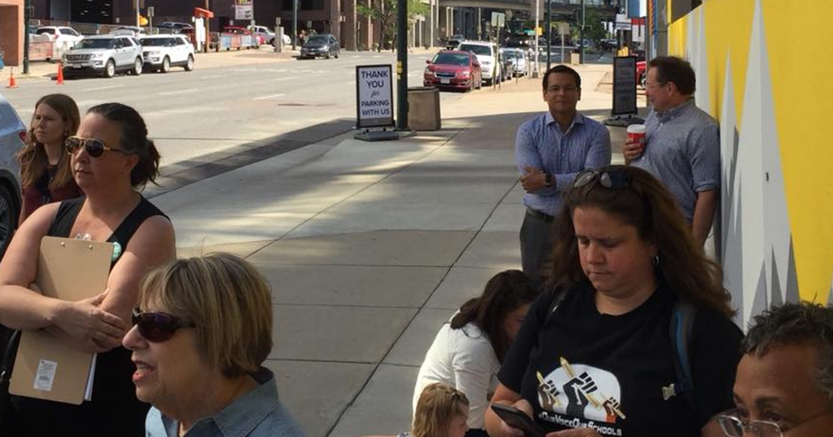 DCTA President Henry Roman and A+ Colorado CEO Van Schoales talk outside an Our Voice Our Schools event where community members released demands for the Denver Public Schools superintendent search.