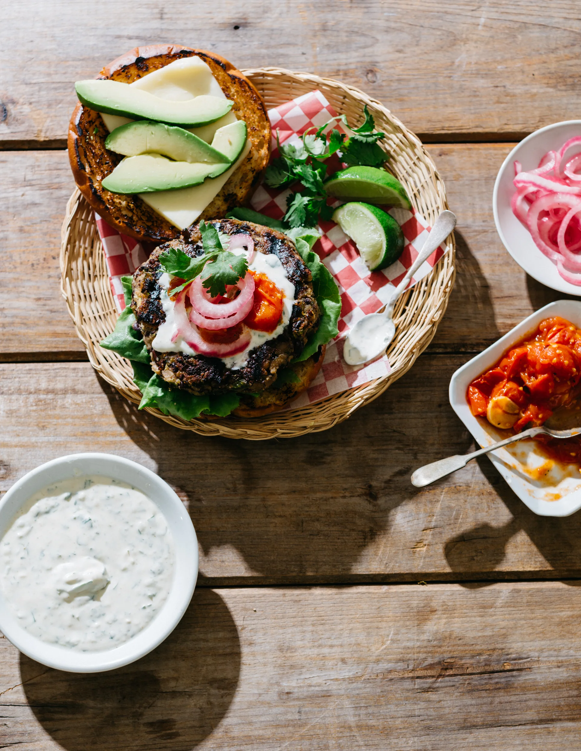 Mexican Black Bean Tortas with Tomato Jam, Pickled Onions, Avocado, and Cilantro-Lime Crema