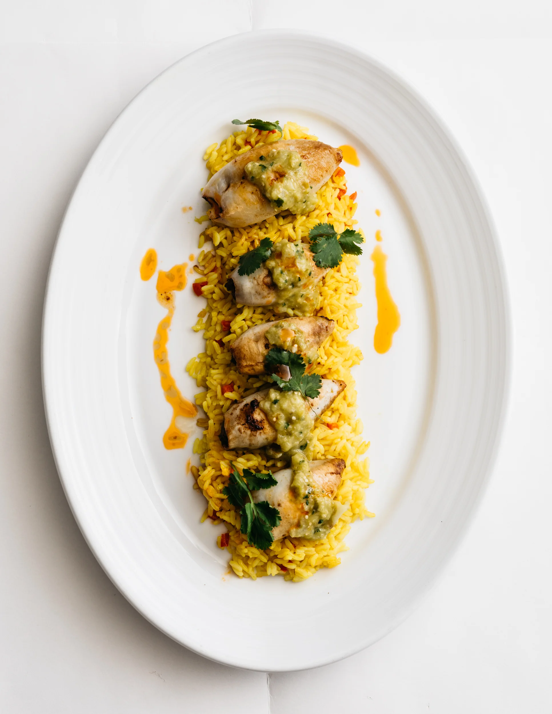 Chorizo-Stuffed Squid with Yellow Rice and Salsa Verde