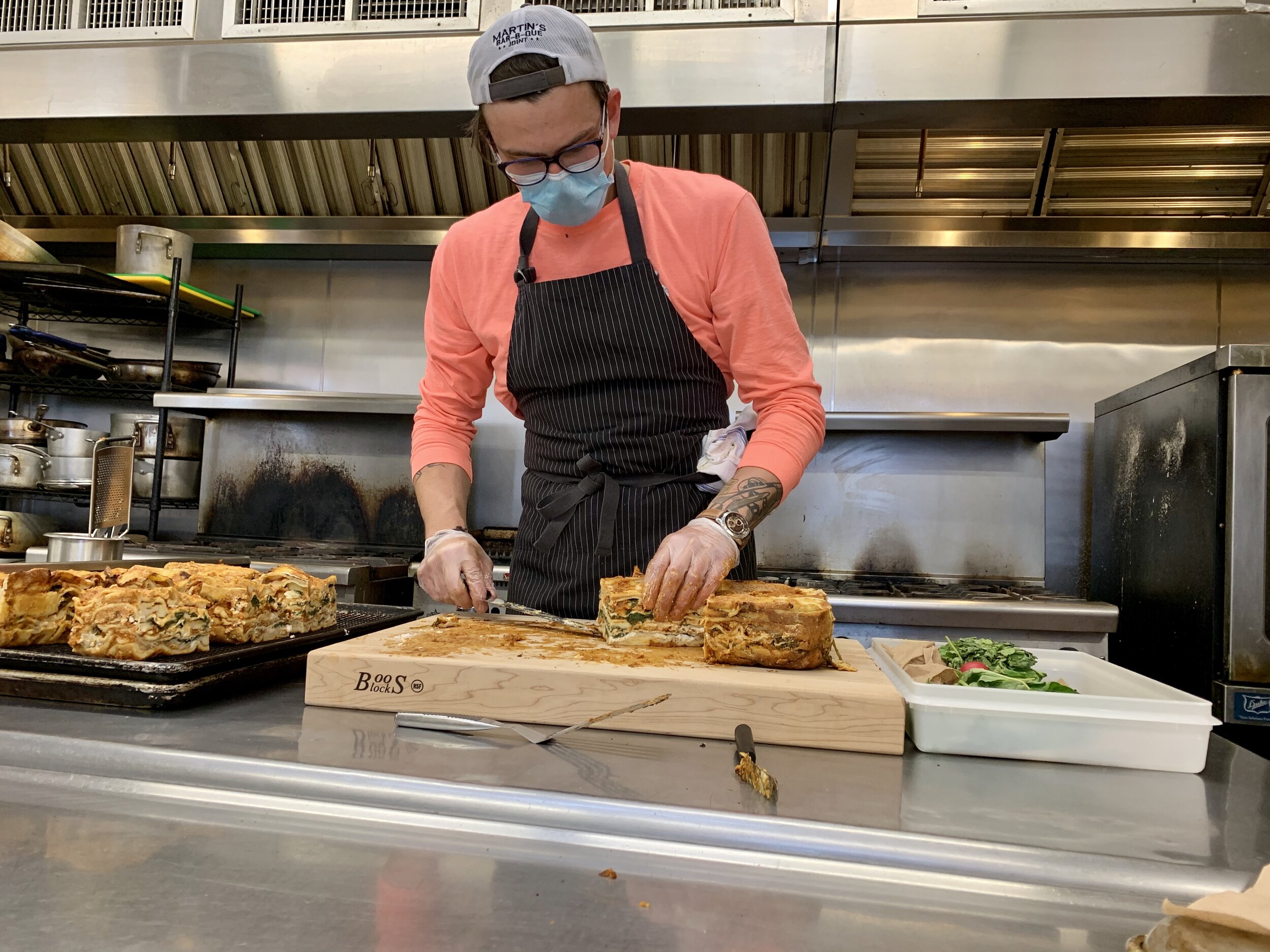 Chef Schwartz preparing Bountiful's signature 6-layer lasagne; photo by Julian Cohen