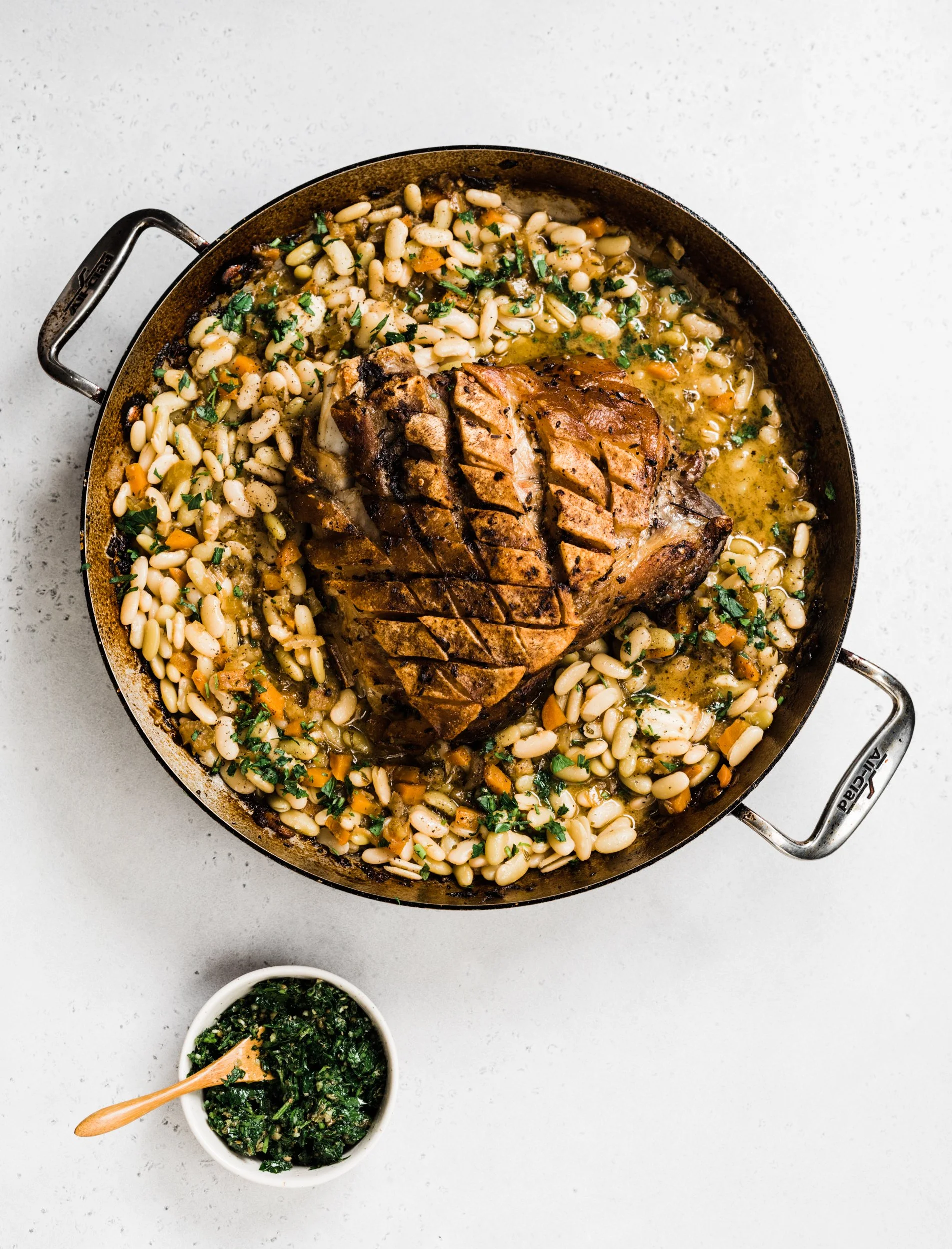 Porchetta-Style Bone-In Pork Picnic Shoulder with White Beans and Salsa Verde