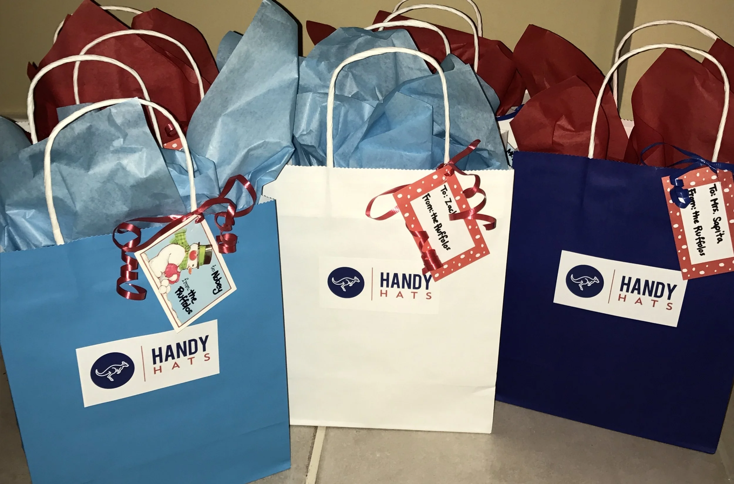  Handy Hats wrapped up as gifts in custom Handy Hat bags 