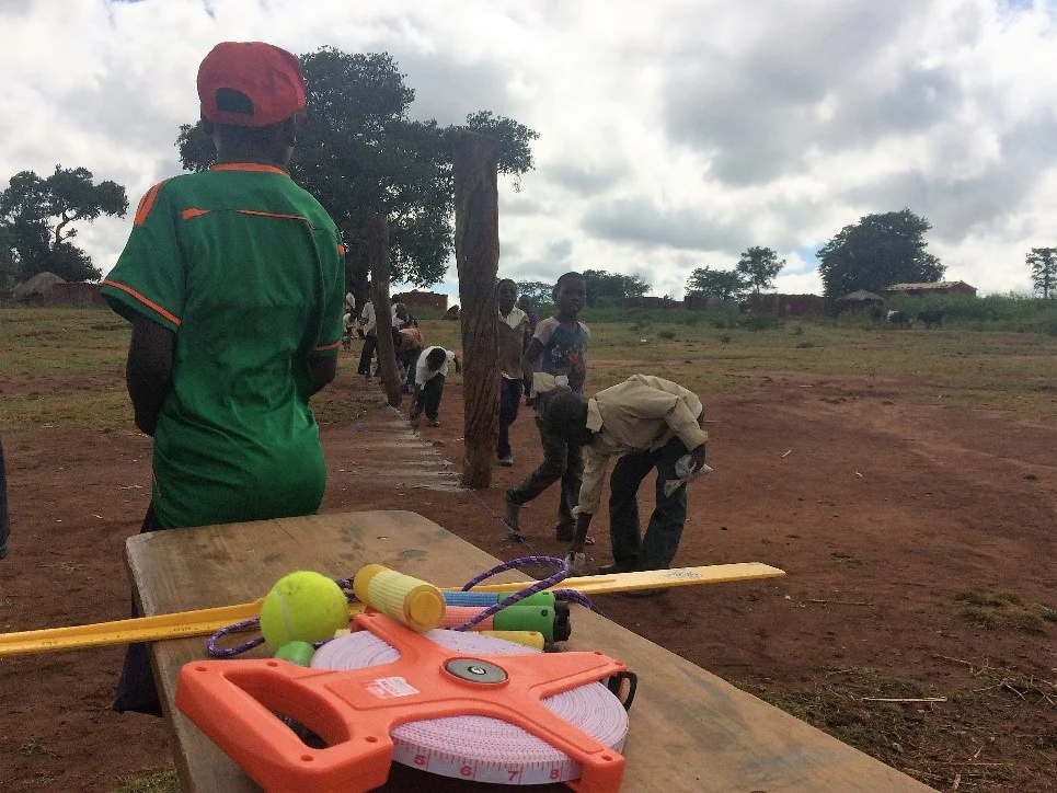 Students busily preparing the perimeter of the track 