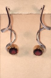Sterling silver garnet dangle earrings with gold plate detail. $345