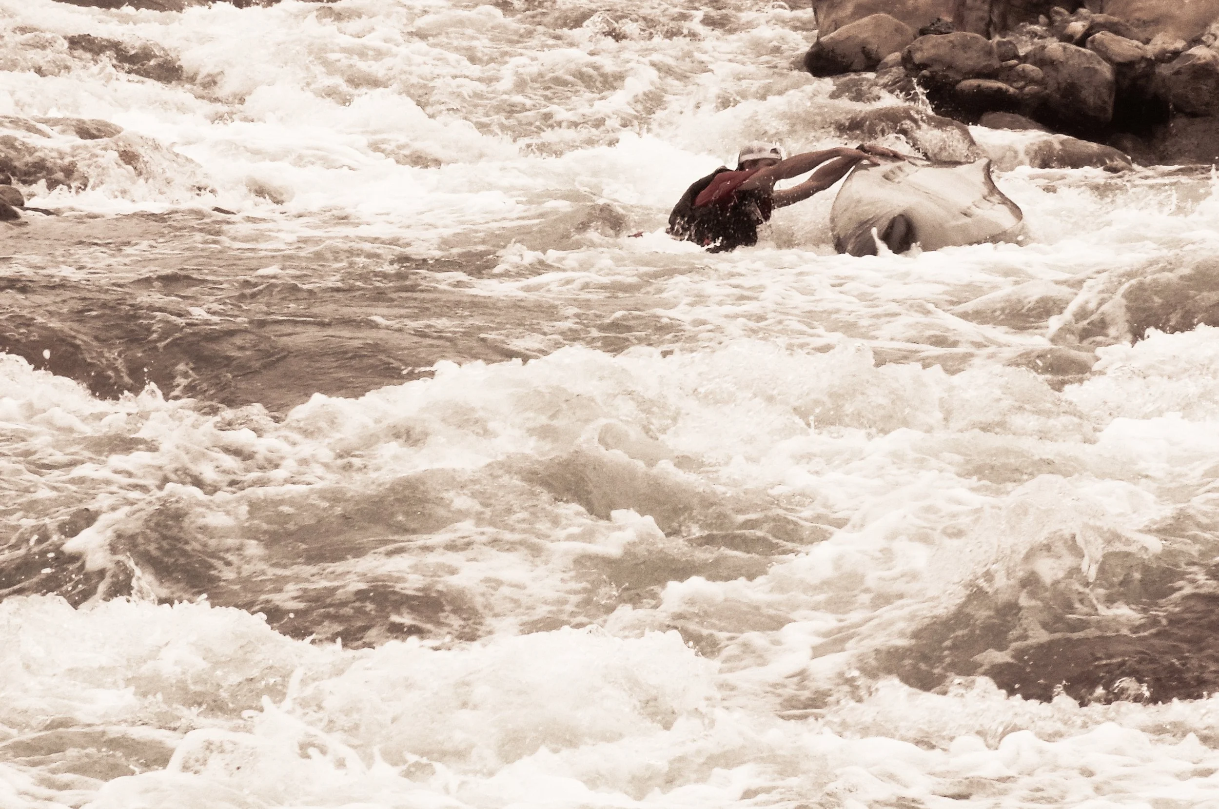 Luke taking an uncommon spill after entering a large rapid
