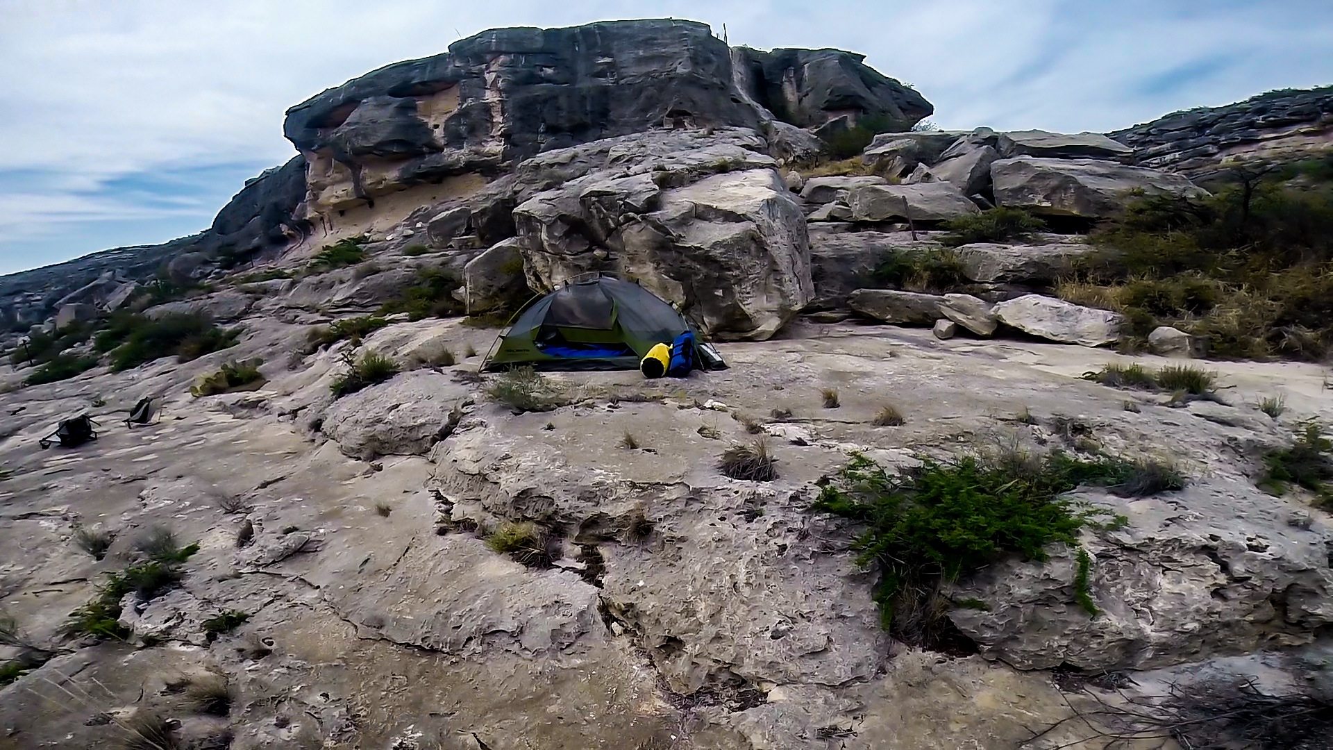 Camp below the big cliff that looks like a face carved in stone.