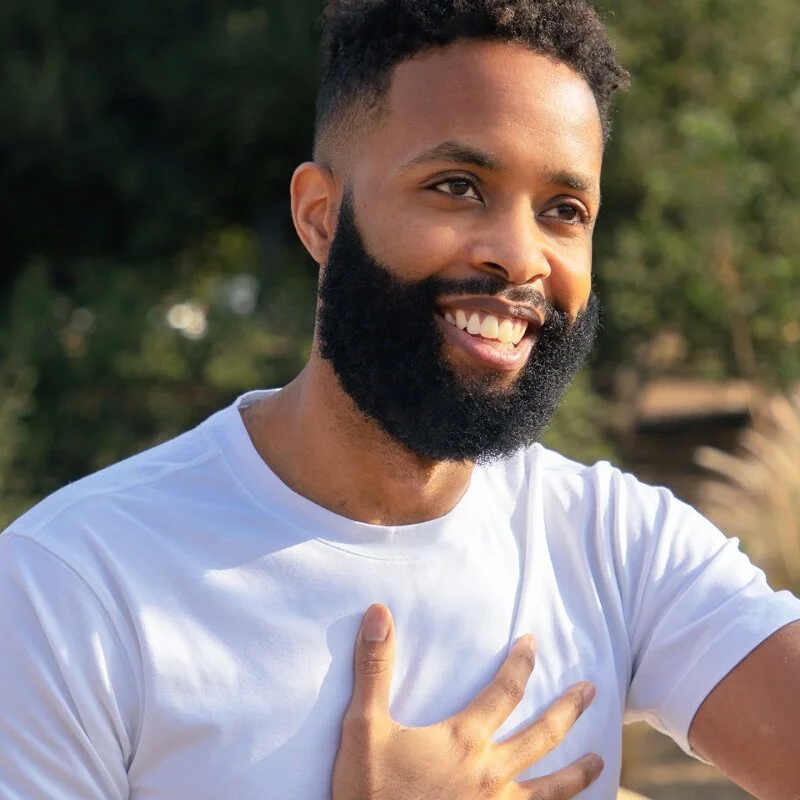 Curtis Smith the mindfulness training expert with beard smiling with his hand on his chest