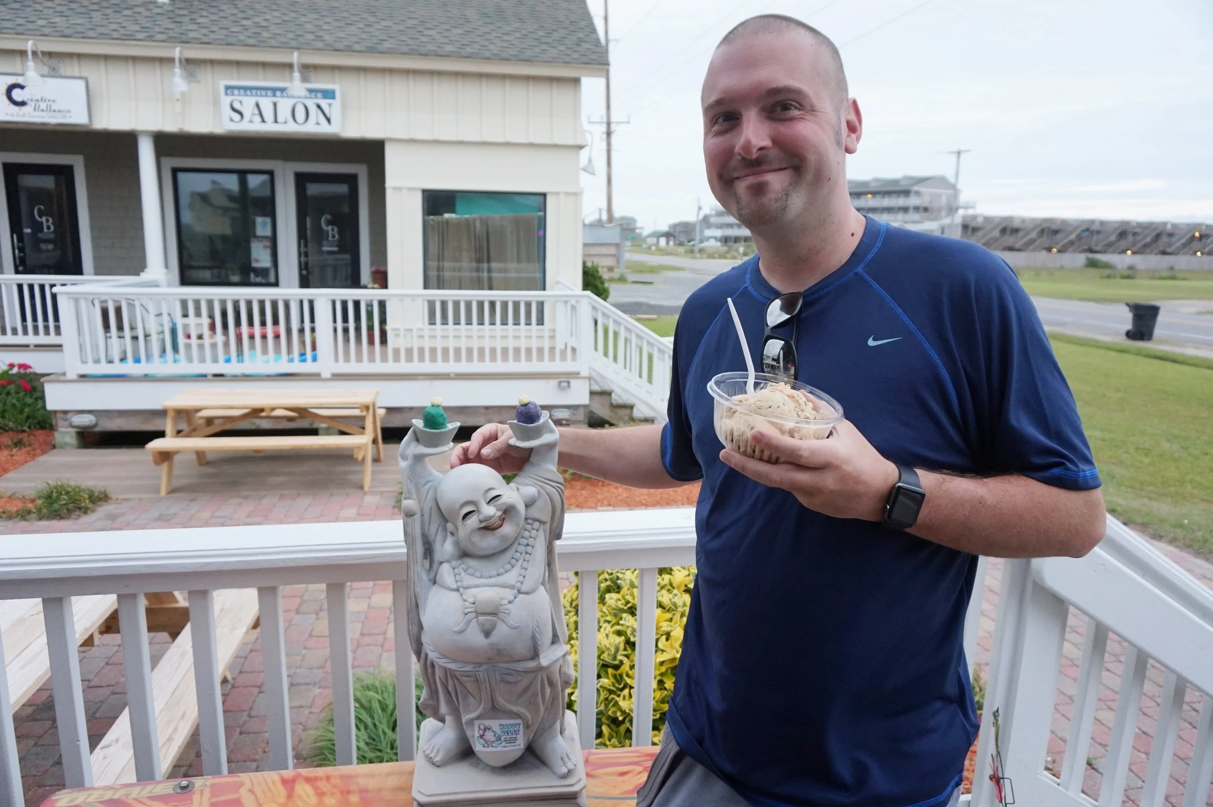 Happy Buddha and a happy husband outside of Happy Belly! 
