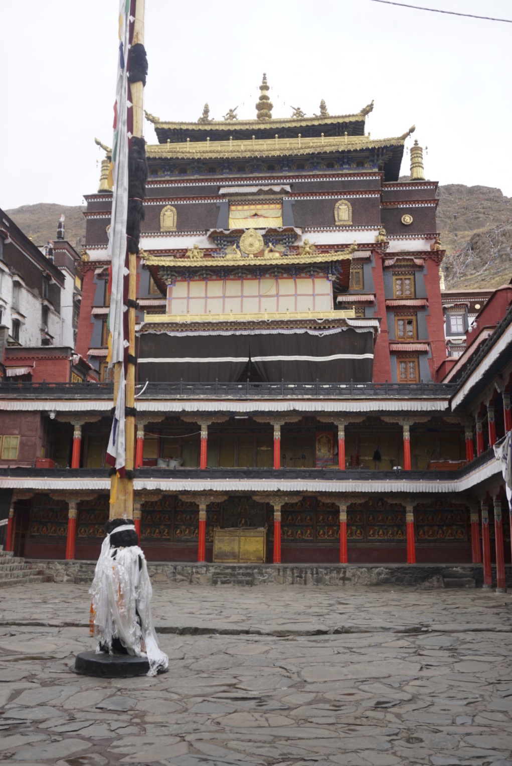 The courtyard of Tashailhunpo monastery witn flagpole in the foreground