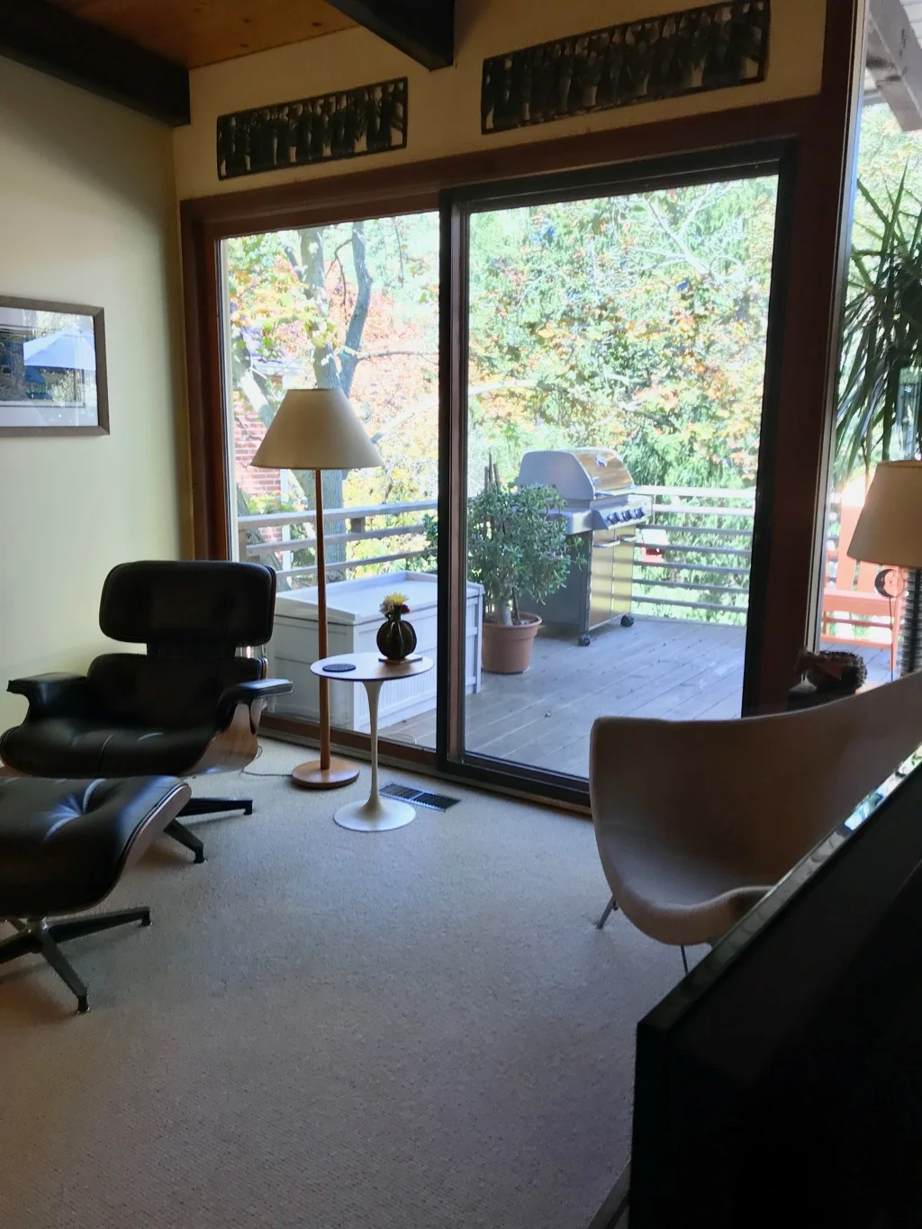 DECK OFF LIVING ROOM WITH EAMES LOUNGE CHAIR