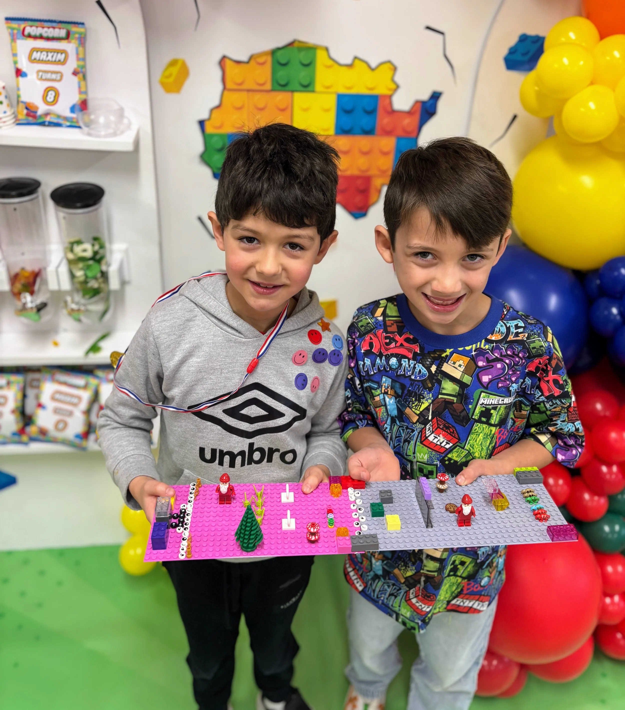 Kids celebrating a Brick Master LEGO birthday party in London, UK, holding their custom LEGO builds on baseplates, showcasing creative play, hands-on LEGO building, and fun children’s birthday party activities.