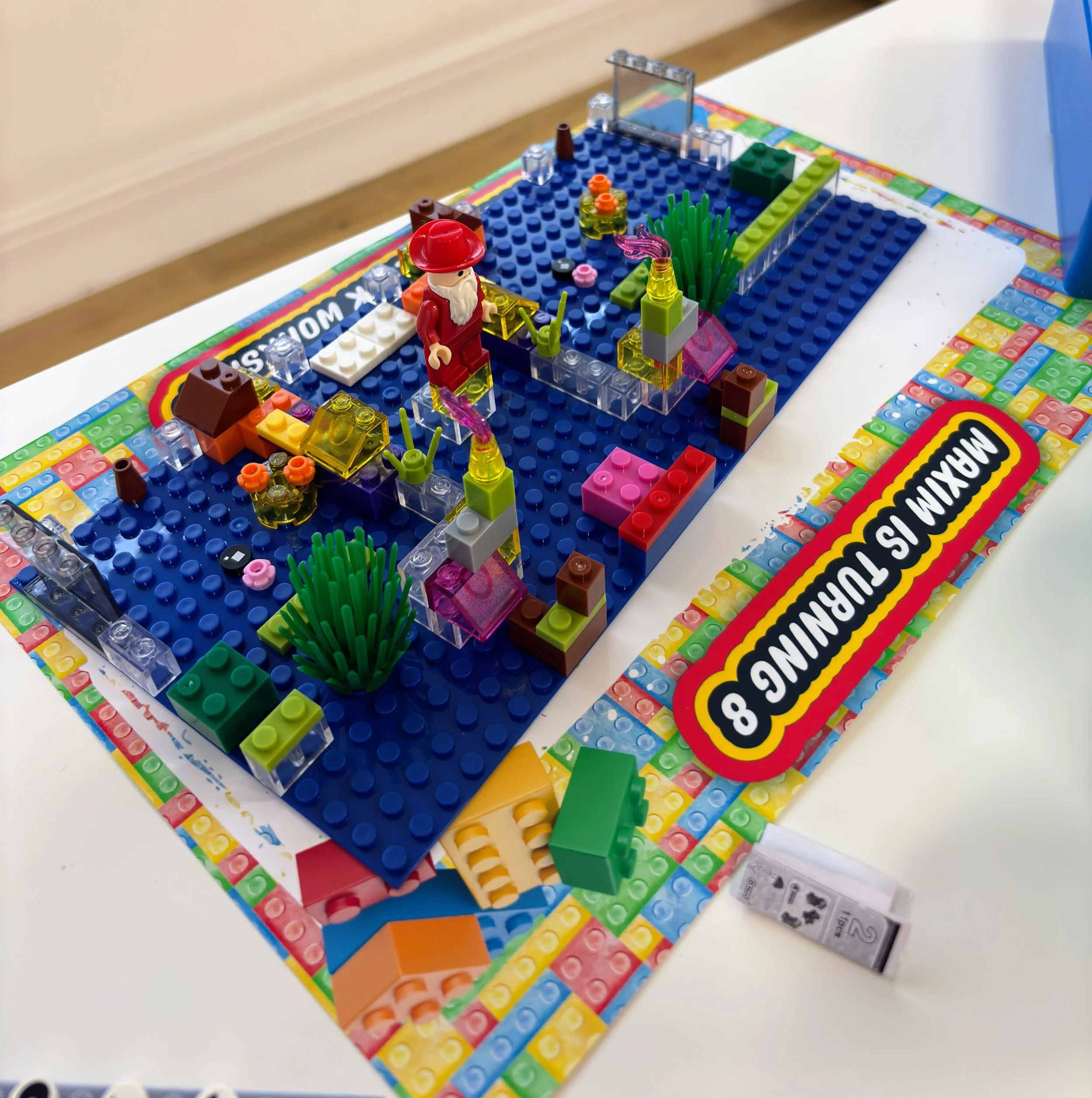 Brick Master LEGO birthday party activity in London, UK, featuring a child-built LEGO scene with minifigures and colorful bricks on a baseplate, showcasing hands-on LEGO building, creative play, and kids birthday party entertainment.