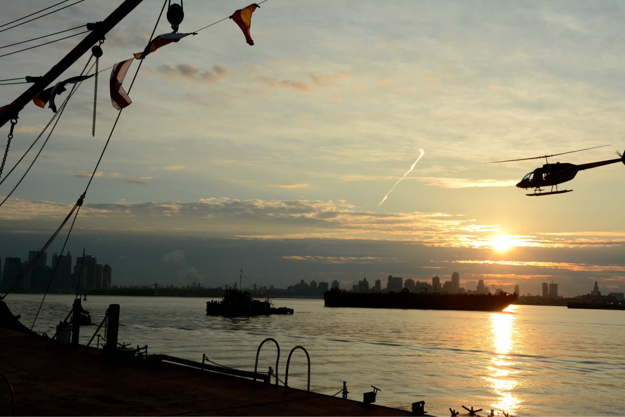  A helicopter flies overheard as Queen Mary 2 sails into New York for Cunard's 175th anniversary celebration. 