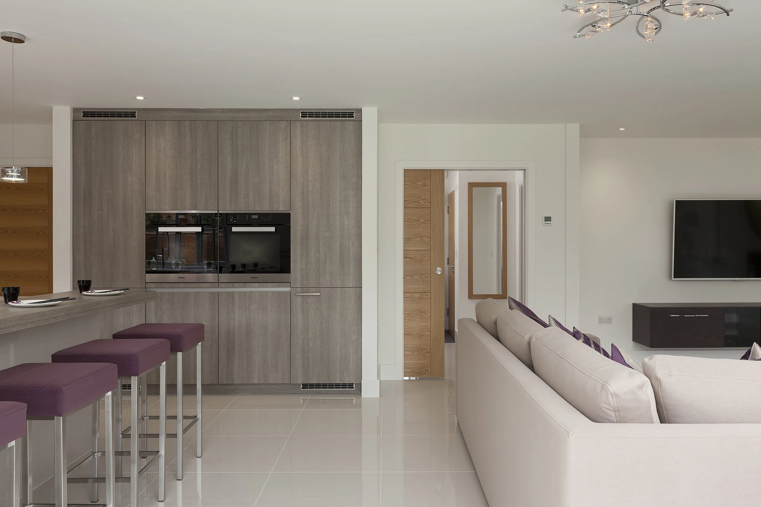 Open living room and kitchen dining area. Polished porcelain tiling throughout ground floor to provide a contemporary and clean aesthetic to the interior living space.