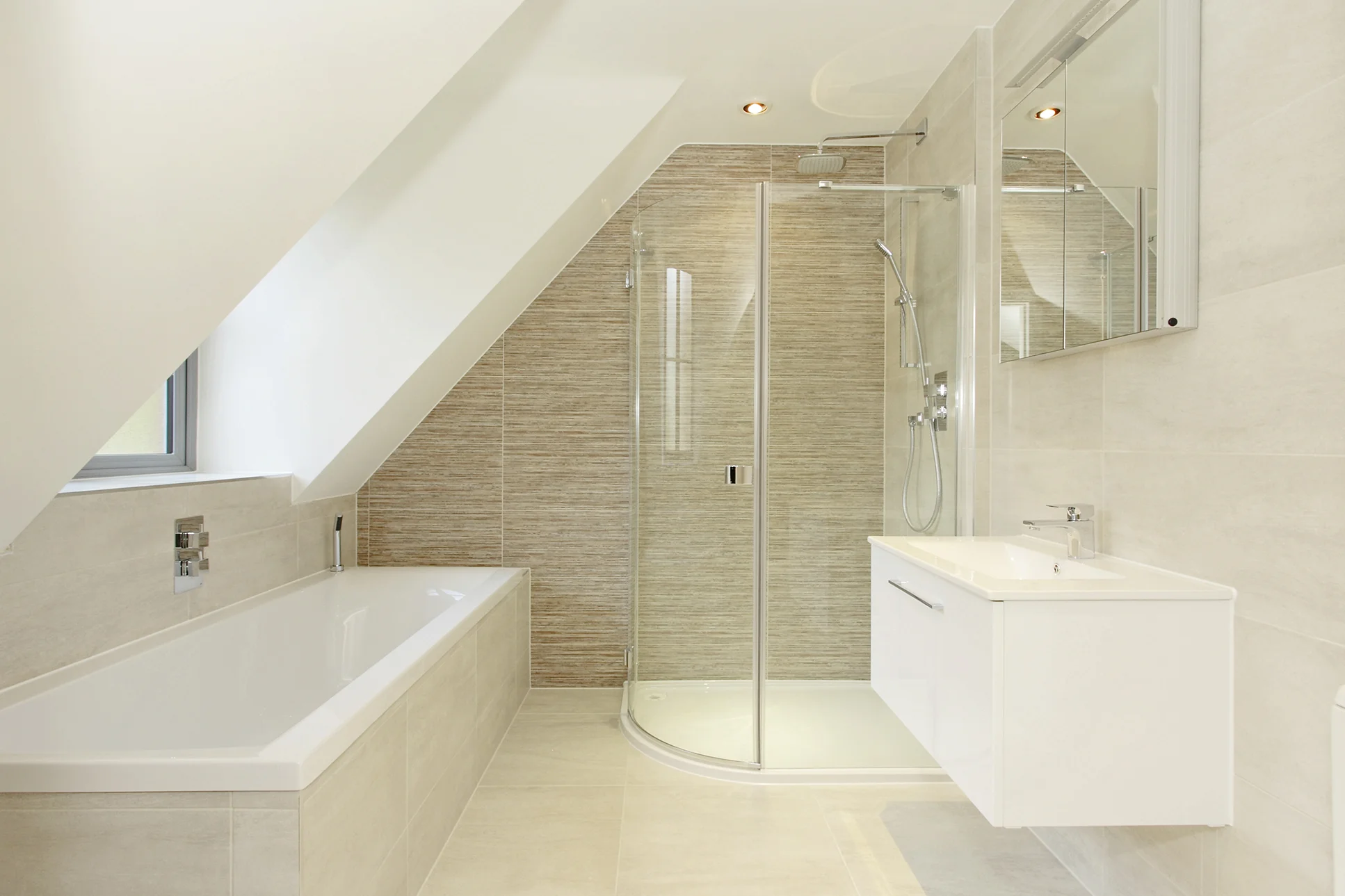 Fully fitted bathroom incorporating porcelain tiling, quadrant shower unit and wall hung basin unit.