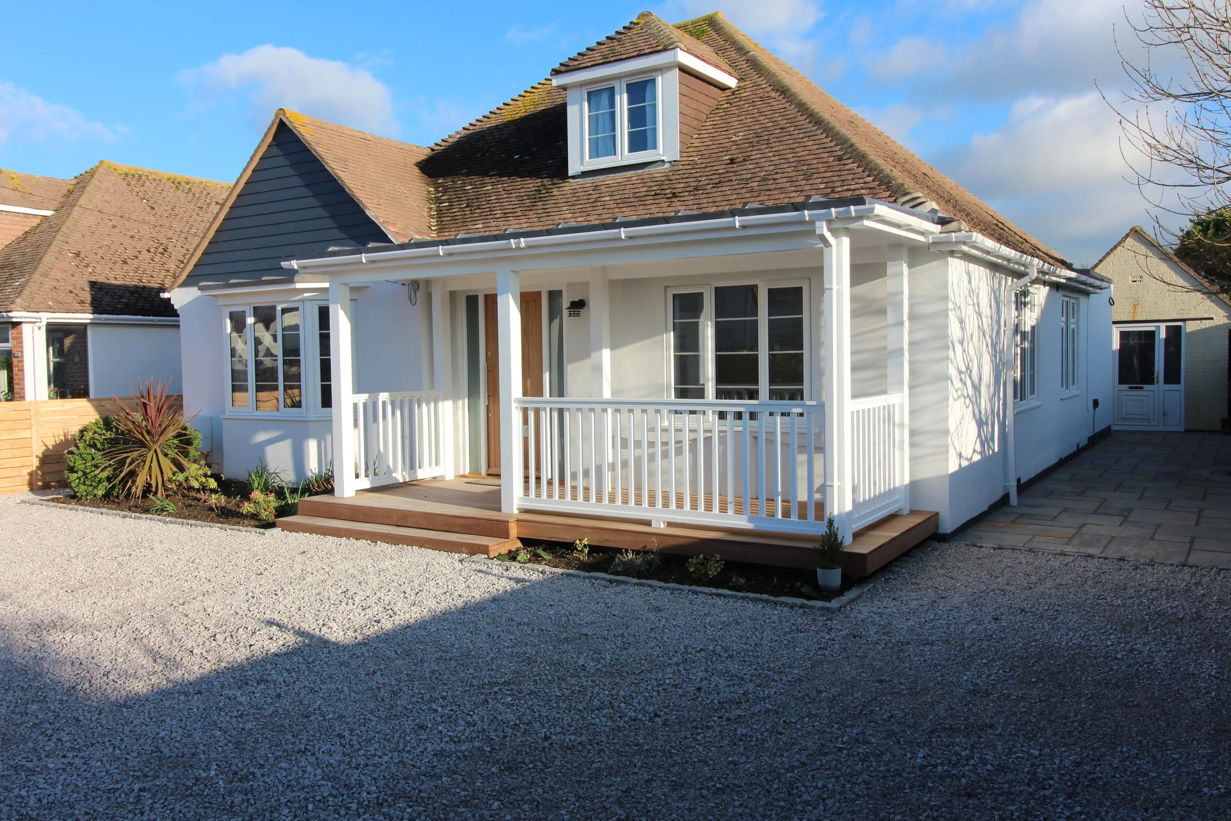 A softwood porch and new windows were added to the front elevation of the property. Iroko hardwood was used for the decking and lead roofing gave a traditional feel.