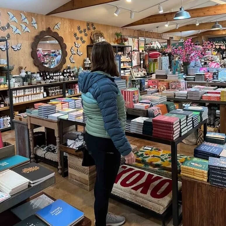 emily in local boutique with books