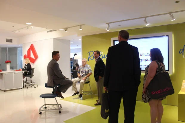 A NeoCon visitor tries out different ways to sit on the Ruckus chair. [DNAinfo/Kayla Martinez]