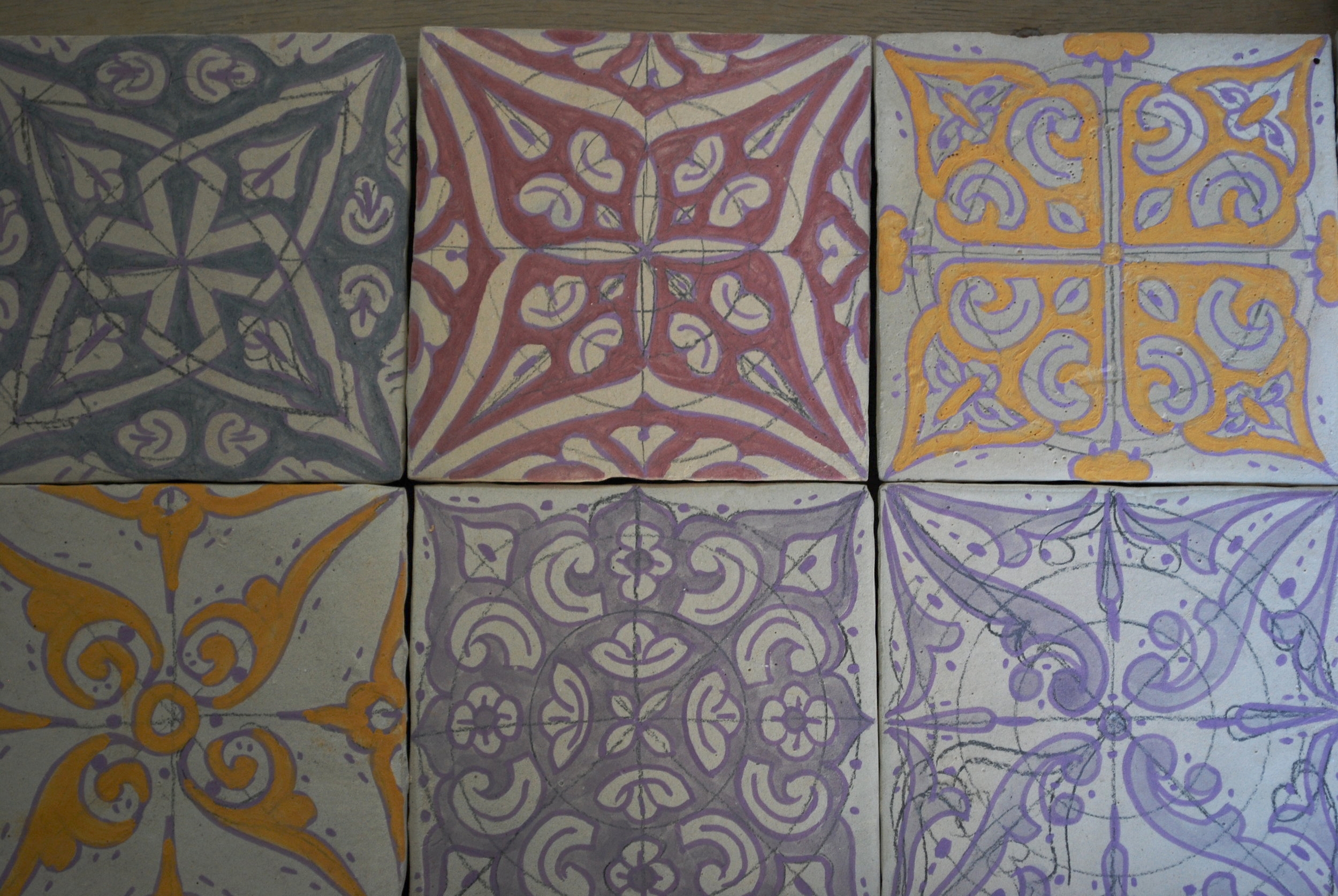 These decorative tiles await their turn the kiln.
