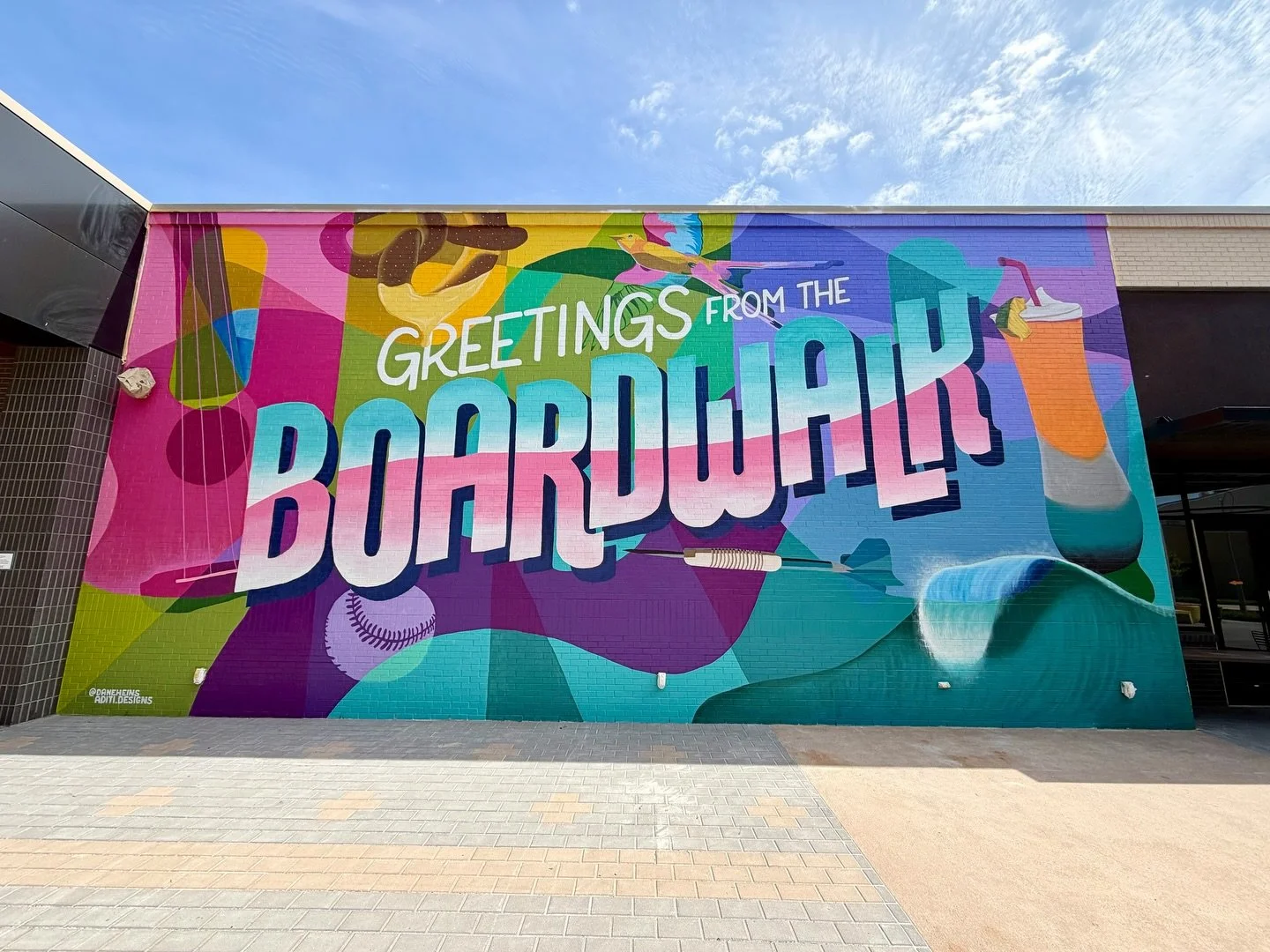 Summer just got a little more colorful at @okanaresort 🌈 So thrilled to finally share this giant mural that will greet visitors and locals alike at The Boardwalk at OKANA! Packed with vibrant colors and nods to the unique restaurants and activities 