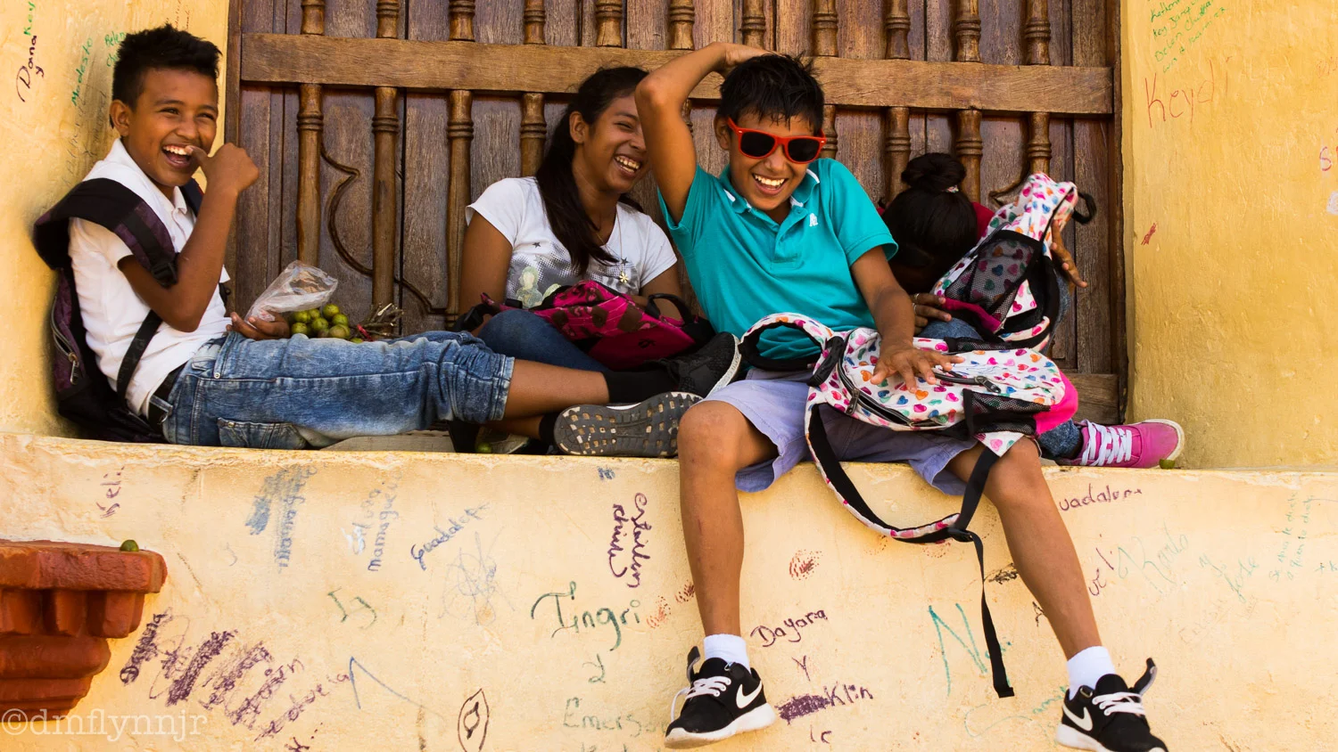 Kids after school pass the time in the window of the cathedral in Sutiava.