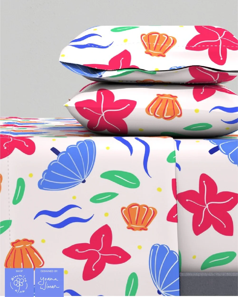 Children's bedding sheet set using a surface pattern with hand drawn sea shells parasols and flowers found in the summer by the beach