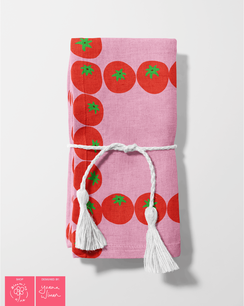 A folded napkin using the fruity grid surface pattern collection specifically the tomato grid in red and pink