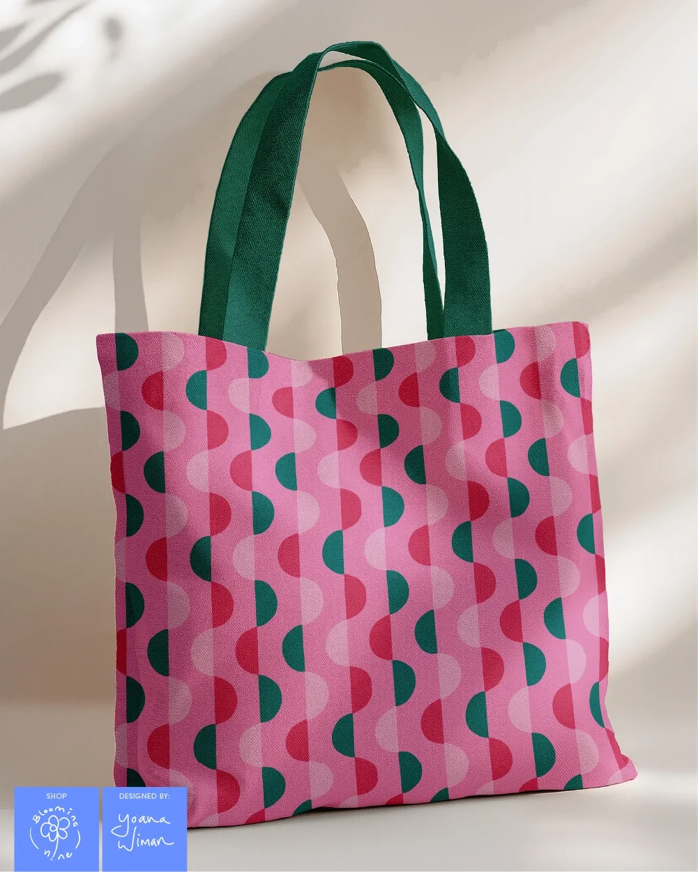 geometric half circle repeat pattern in pinks and dark teals used on a canvas tote bag
