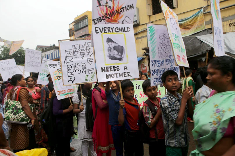 Sex workers and their children take part in an demonstration in 2014 seeking better rights and a halt to girl trafficking in the red-light area of Kolkata, India. Photo Credit: CNS photo/Pial Adhikary, EPA