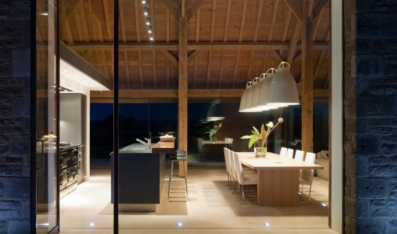 A whole wall of glass has been added to this barn conversion which, with a mixture of clever lighting design, dramatically showcases the salvaged structure and contemporary interiors. Stow On The Wold
