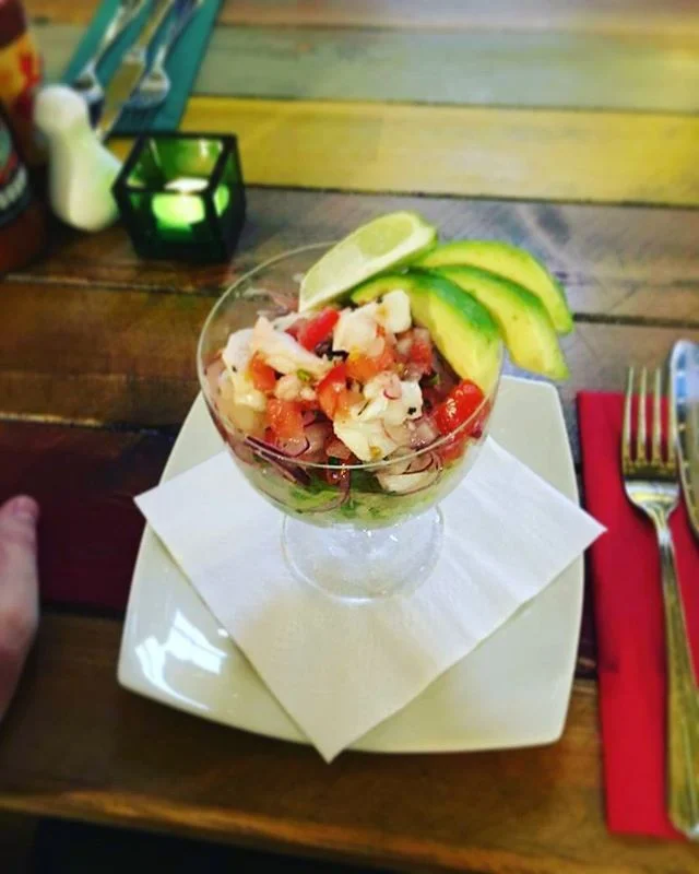 Amigos newest special is the Fresh ceviche cocktail with sliced avocado and chips.
