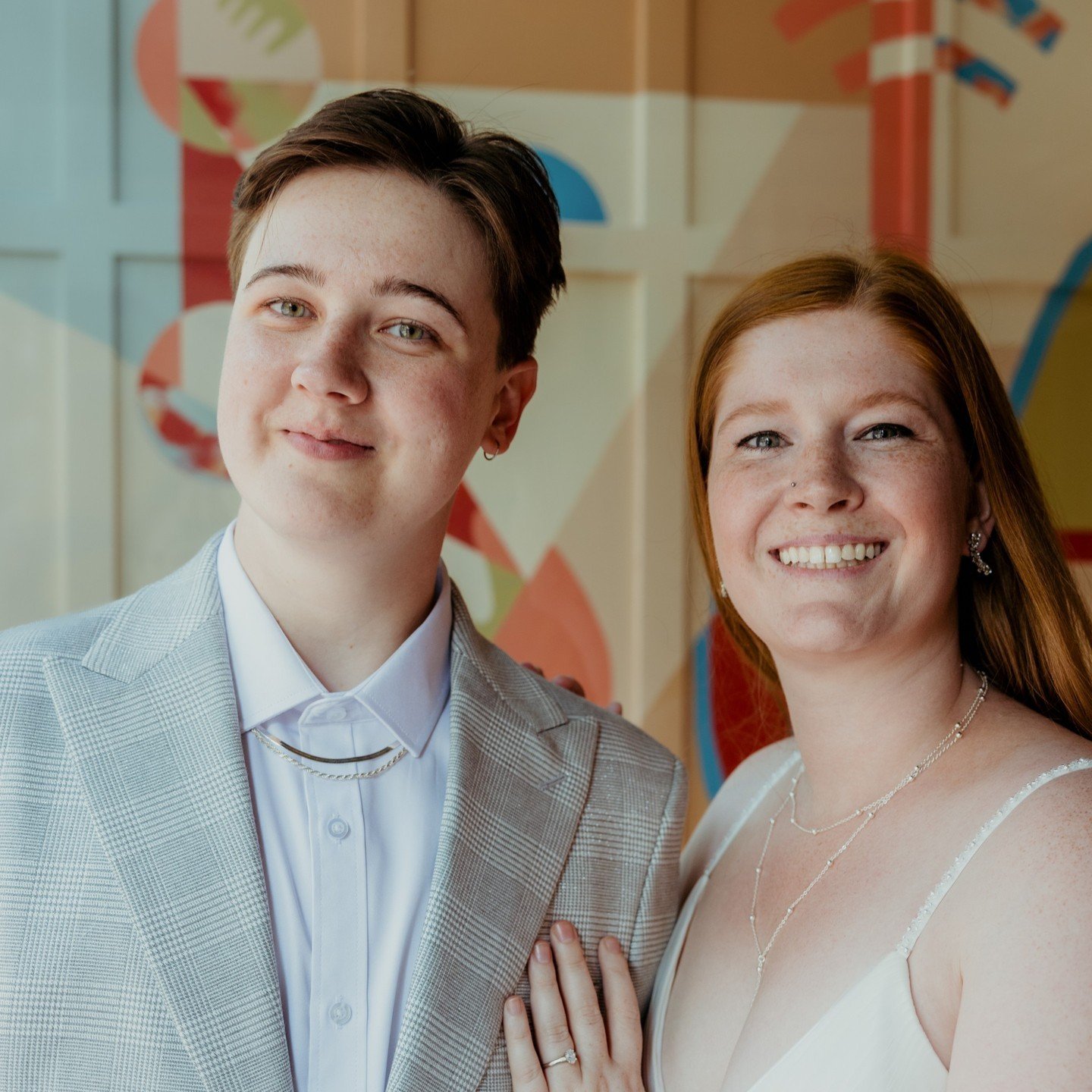 Aren't these two the cutest? (That's a rhetorical question, they definitely are) 🎉💖🌈
.
.
.
.
.
[Image Description: A white non-binary person with short dark brown hair is wearing a light grey plaid suit with white button up shirt. They are looking