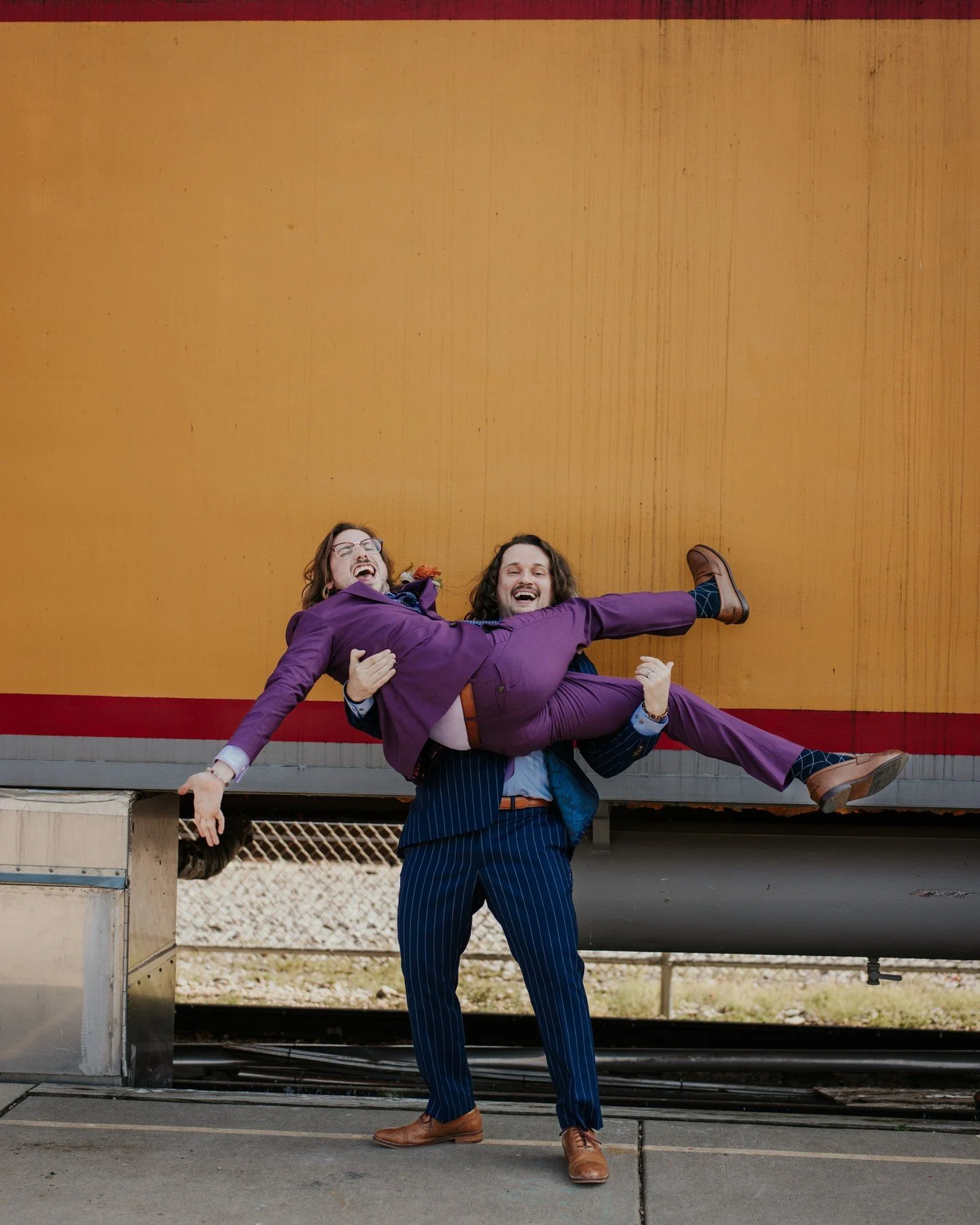 The energy I want to bring into this week: Gay(er) and enthusiastically in love with life! 🏳️&zwj;🌈🤩
.
.
.
.
.
.
[Image Description: A white man with long light brown hair in a purple suit is being held up in the arms of a white man with long curl